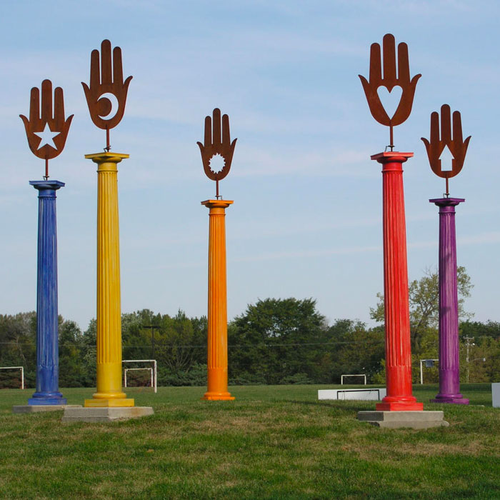 Blue, yellow, orange, red, and purple monument pillars in Urbandale, IA